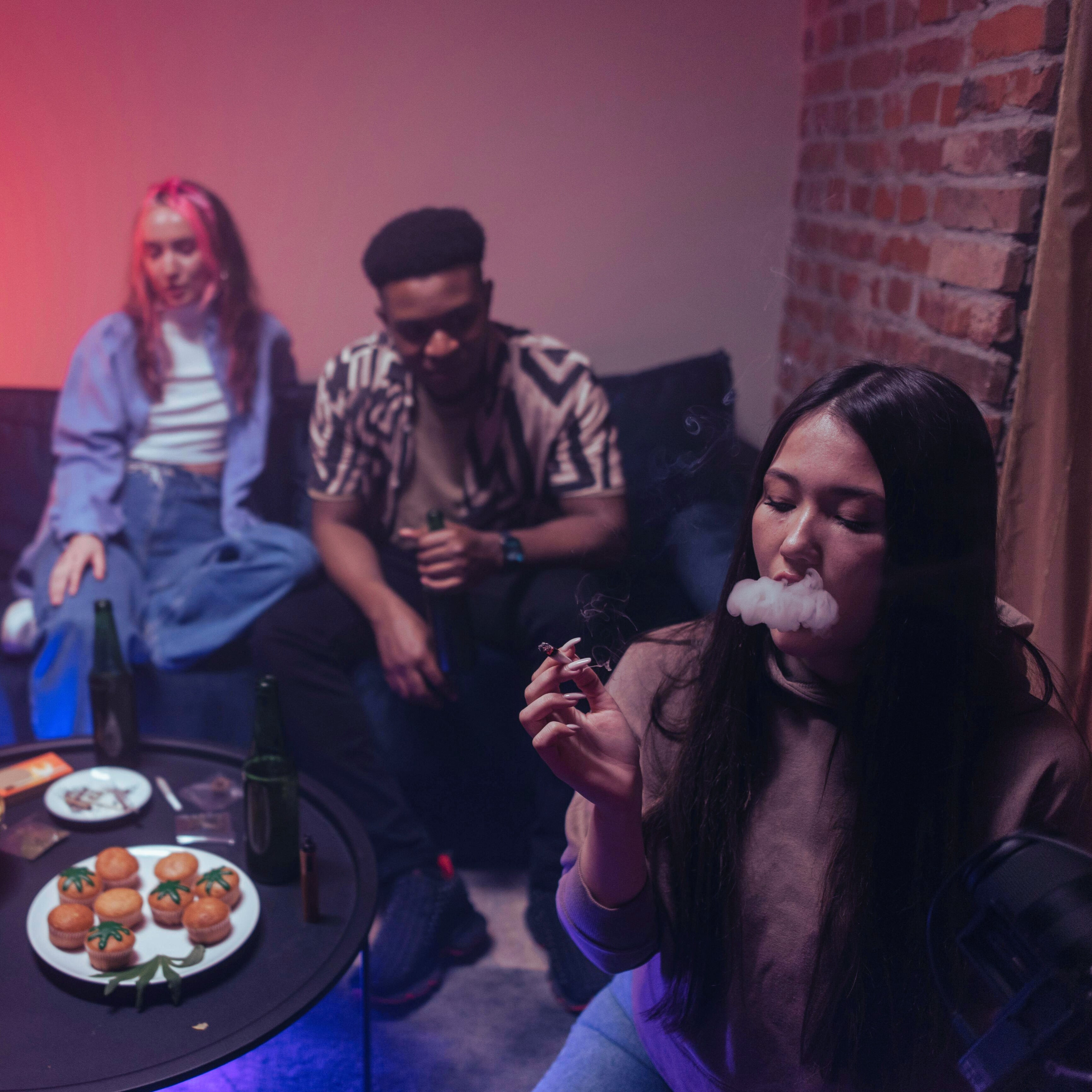 Group of friends relaxing indoors with uplifting vibes, representing StreetStem’s Uplift THCa Flower collection.