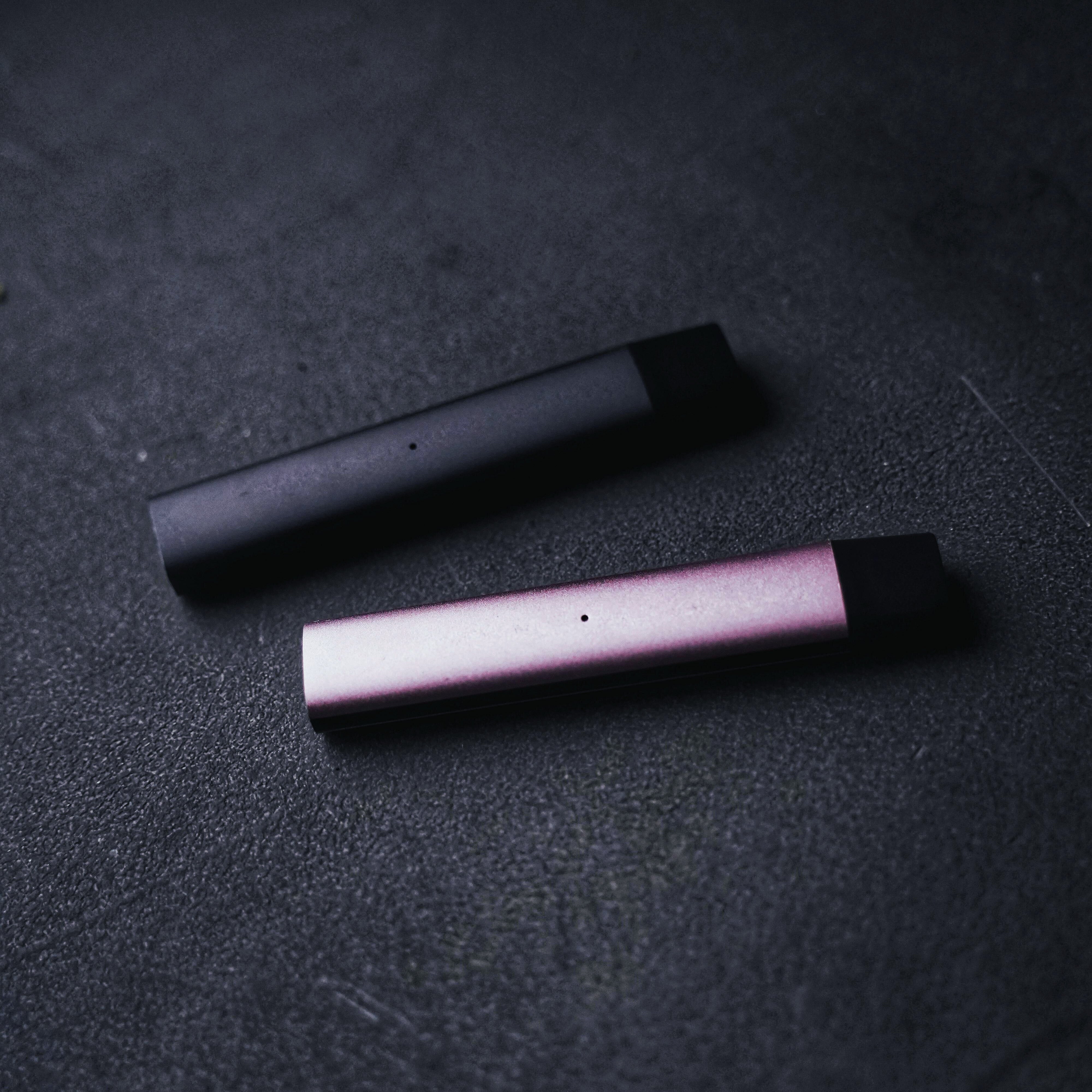 Two sleek THCa vape devices in black and rose tones from StreetStem.