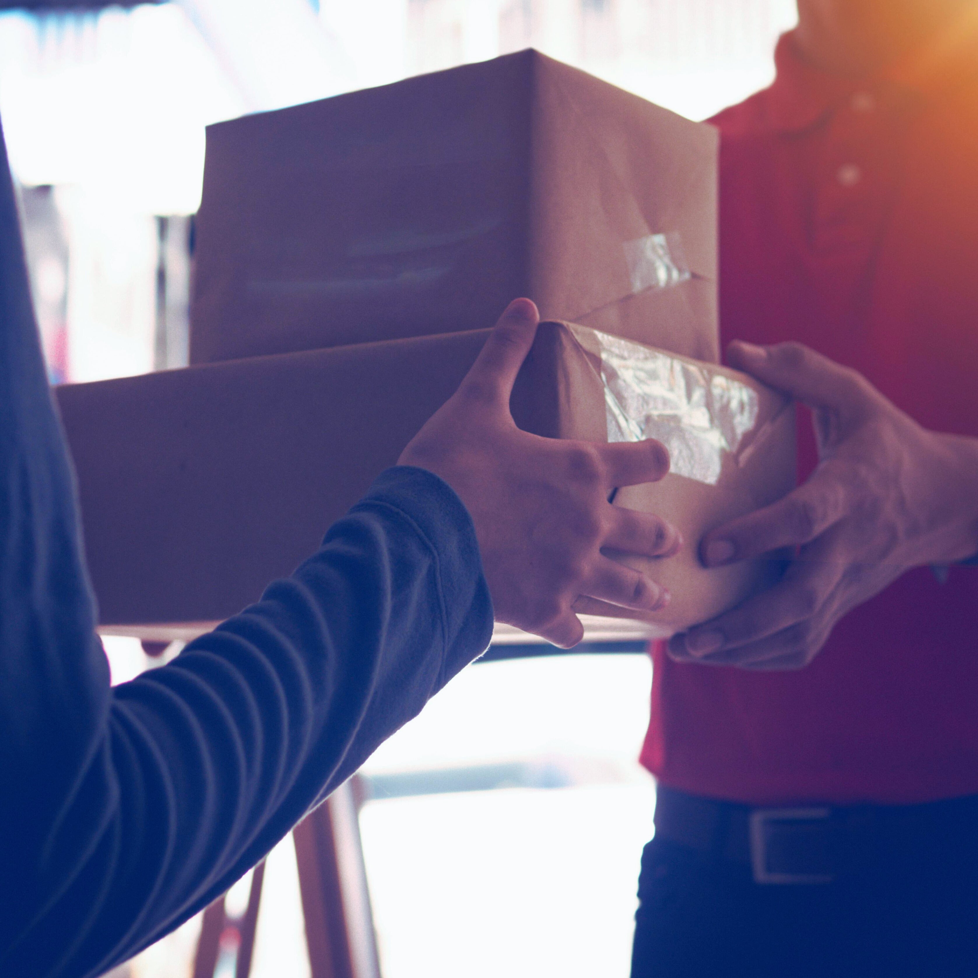 Close-up of a discreet package handoff representing StreetStem’s fast and secure shipping for hemp-derived THCa products.